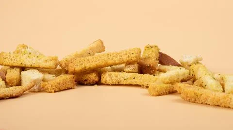 Bread croutons closeup, beer snacks on beige background 스톡 사진