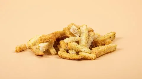 Bread croutons closeup, beer snacks on beige background Stock Photos