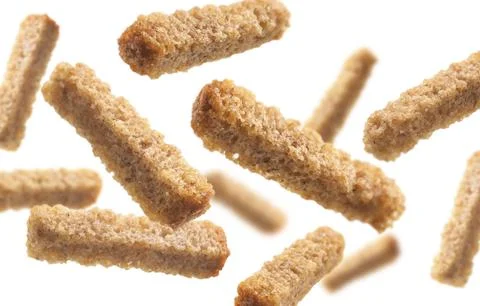 Bread croutons levitate on a white background Stock Photos