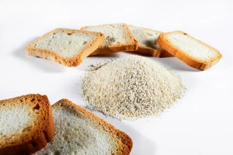 Bread crumbs and biscuits on white background Foto stock