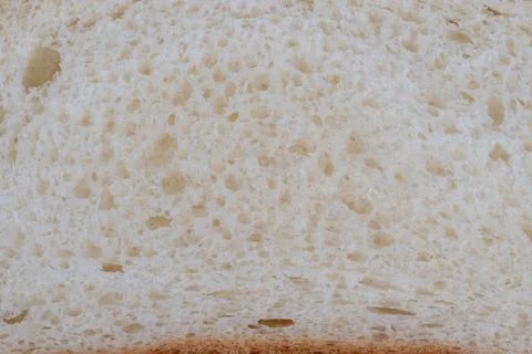 Bread crust detail. Rustic loaf with airy crumb. Closeup of artisan bread textur Stock Photos