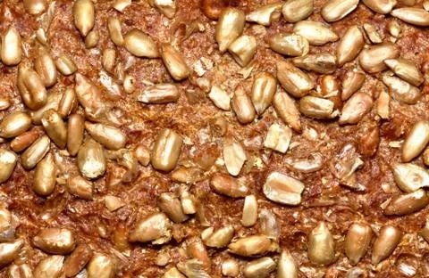 Bread crust texture with pumpkin seeds. Close-up detail. Stock Photos