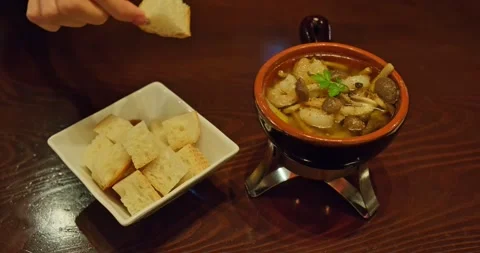 Bread Cube Lifted from Ajillo with Dripping Garlic Oil, Cozy Restaurant Food 스톡 동영상 328620853
