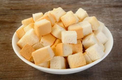 Bread cube in white bowl Stock Photos