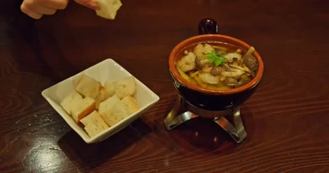 Bread Cubes Dipped into Mushroom and Shrimp Ajillo on Wooden Table, Cozy 스톡 동영상 328620822