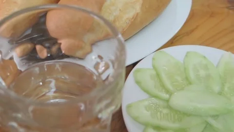 Bread, cucumber and water on the table Stock Footage 70688459