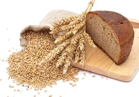 Bread cut on a board, a bag with wheat and ear of the wheat Stock Photos