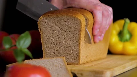 Bread is cut into chunks close-up in slow motion Stock Footage 156258944