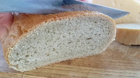 Bread cut with a knife slow motion Stock Footage 95575907