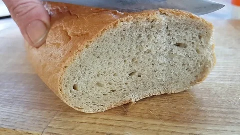 Bread cut with a knife slow motion Stock Footage 95575991