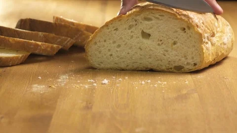 Bread is cut into thin slices on a wooden board Stock Footage 76422928