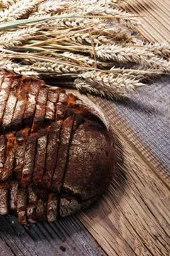 Bread cutted on board from above. Kitchen or bakery poster design. Stock Photos