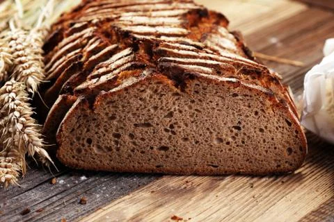 Bread cutted on board from above. Kitchen or bakery poster design. Stock Photos