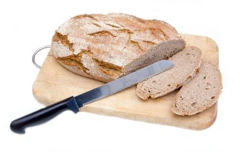 Bread on cutting board with a knife on white background Stock Photos