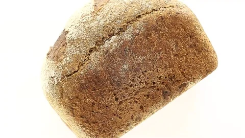 Bread dark with flour, lying on its side rotates, turning, top view 動画素材 148495146