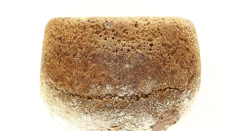 Bread dark with flour, lying on its side rotates, turning 스톡 동영상 148878894
