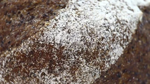 Bread dark with flour, rotates clockwise, turning, top view Stock Footage 148878100