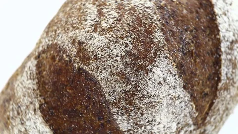 Bread dark whole, with flour, rotates clockwise, turning, top view 스톡 동영상 148878089
