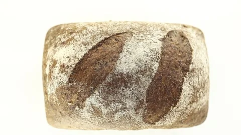 Bread dark whole, with flour, rotates counterclockwise, turning 動画素材 148878839