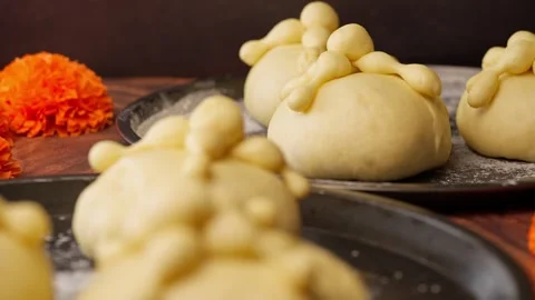 Bread of the dead or hojaldras before baking and cempasuchil flowers Stock Footage 281460102