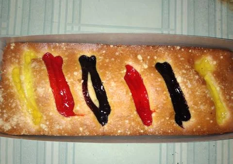 	A bread with different colored decorations on top Stock Photos