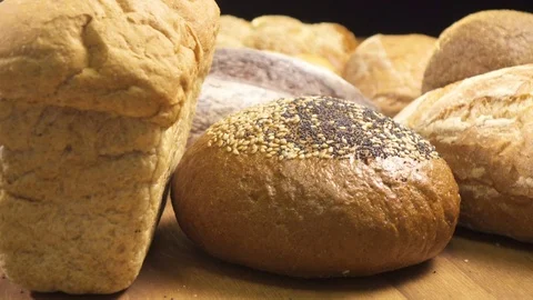 Bread of different kinds is spinning on the table Stock Footage 76428319