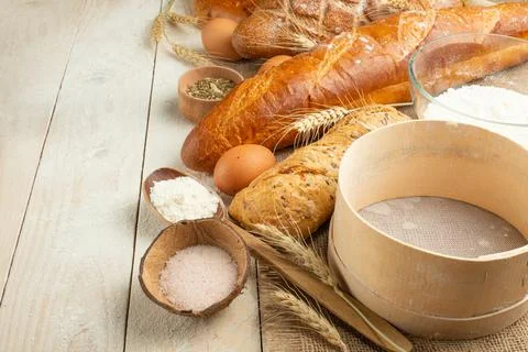 Bread of different varieties on a wood background with copy space background. Stock Photos