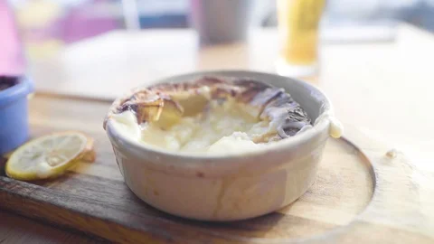 Bread dipping in to pot of melted cheese Stock Footage 101279364
