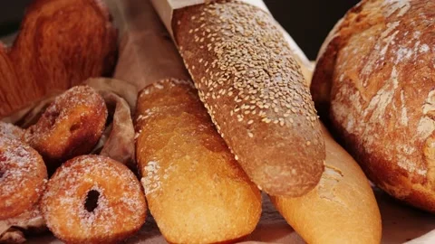 Bread displayed by the baker, assortment of Spanish baguette and traditional Stock Footage 233931745
