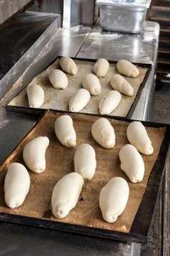 Bread dough on baking trays Stock Photos