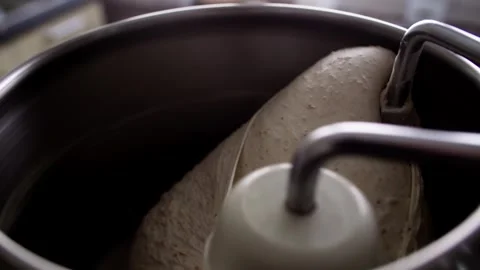 Bread dough being kneaded in home stand mixer; close-up, slow camera push in. Stock Footage 343629026