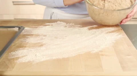 Bread dough being shaped into a loaf on a floured work surface Stock-Footage 24672965