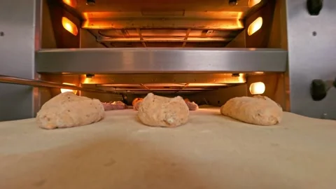 Bread dough come to the bread oven Stock Footage 155521573