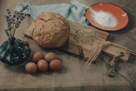 Bread dough with eggs and ingredients to make traditional rustic bread. Stock Photos