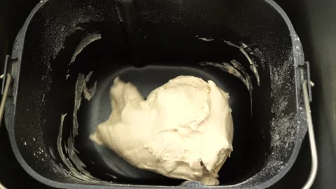 Bread dough kneading in slow motion inside bread machine Stock Footage 305877756
