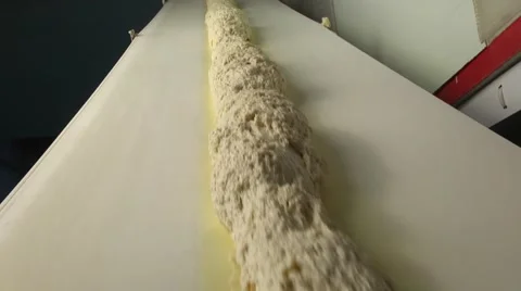 Bread. Dough moves on a conveyor belt Stock-Footage 61073989