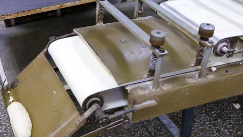 Bread dough pieces fall off the conveyor belt Stock Footage 128603669