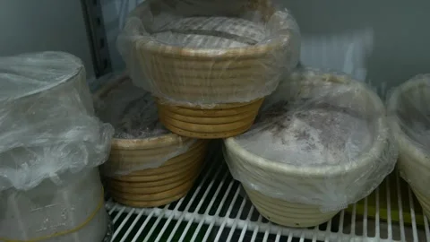 Bread Dough Proofing in Banneton Baskets Inside Refrigerator Stock Footage 340186390