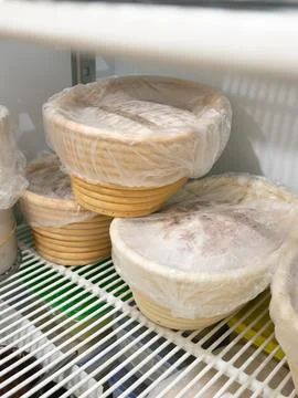 Bread Dough Proofing in Banneton Baskets Inside Refrigerator, Bakery Fermen.. Stock Photos