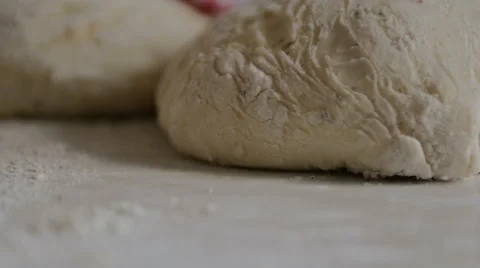 Bread dough ready to be shaped flower on table tracking left Video stock 43815326