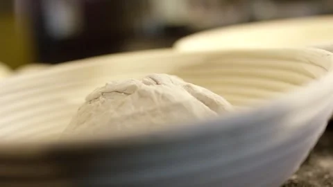 Bread Dough Resting in Ribbed Oval Proofing Basket, Warm Bakehouse, Macro Shot Vídeo Stock 341339645