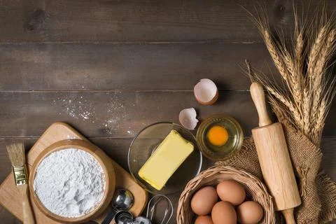 Bread flour with fresh egg, Unsalted butter and accessories bakery on wood .. Stock Photos