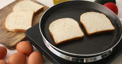 The bread is fried in butter or oil in a frying pan. Stock Footage 250263109
