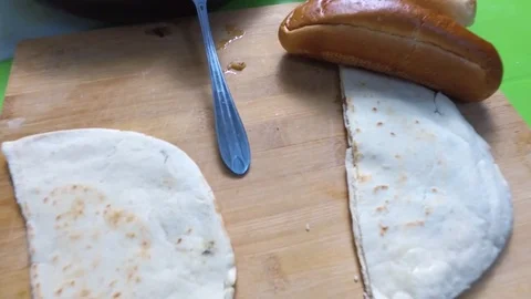 Bread, frying pan with meat and potatoes on the table Stock Footage 81680812
