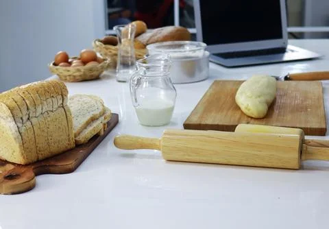 Bread glass milk and eggs and kitchen baking utensils Stock Photos