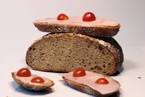 A bread with ham and tomatoes as snack for us Stock Photos