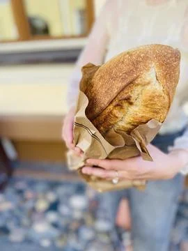 Bread in hands in a bag Stock Photos