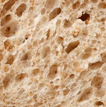 The bread has a rough texture with holes in it 스톡 사진