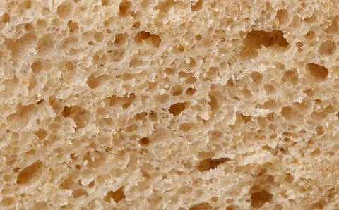 The bread has a rough texture with holes in it 스톡 사진