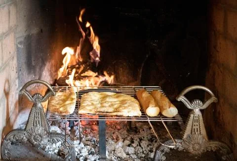 Bread heating on a rack over hot coals Stock Photos